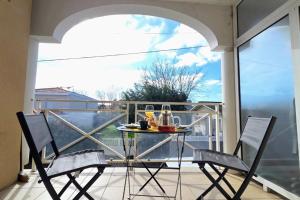 a balcony with a table with drinks on it at Spacious apartment in La Teste-de-Buch in La Teste-de-Buch