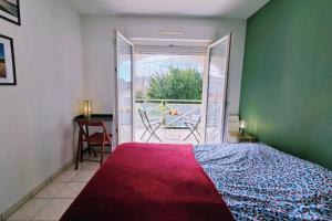 a bedroom with a bed and a view of a balcony at Spacious apartment in La Teste-de-Buch in La Teste-de-Buch +12 photos