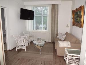 a living room with a couch and a table at Onnela in Saarijärvi