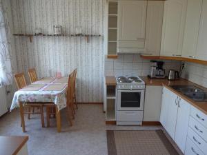 a kitchen with a table and a stove top oven at Onnela in Saarijärvi