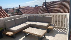 a couch and a coffee table on a balcony at Casa del Mare in Vodice
