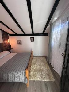 a bedroom with a bed and a large window at Casa del Mare in Vodice +1 photo