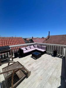 a patio with a couch and a table on a roof at Casa del Mare in Vodice