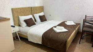 a bedroom with a large bed with two towels on it at Apartmani Tajra in Donji Štoj +5 photos