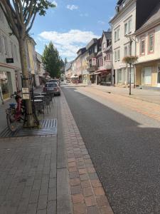 an empty street in a town with tables and buildings at Diezer Apartments II City in Diez