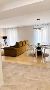 a living room with a couch and a table at Aurah Home in Tudela