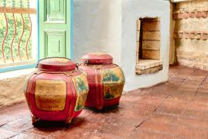 two colorful vases sitting next to a building at Casa Provenzal Hotel Boutique in Villa de Leyva