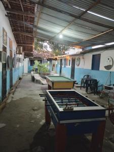 a room with a ping pong table in a building at Vila Sol & Mar Gaibu PE in Cabo de Santo Agostinho
