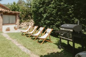a group of chairs sitting next to a grill at Villa Pony in Calonge