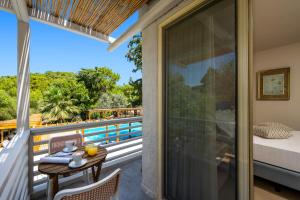 ein Zimmer mit Balkon mit Tisch und Bett in der Unterkunft Casa Trees Hotel in Ixia + 45 Fotos