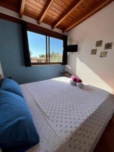 a bedroom with a bed with a teddy bear on it at Villa Alelida in Cinisi