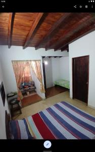 a living room with a bed and a rug at Toucherit Standar triple in La Asunción