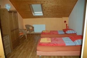 a bedroom with two beds and a table and chairs at Čarodějnický Dvůr in Biskoupky