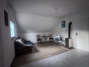 a living room with a couch and a fireplace at Apartmani Mila in Brlog