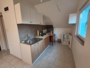 a kitchen with a sink and a counter top at Apartmani Mila in Brlog