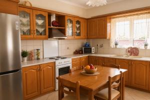 a kitchen with a table with a bowl of fruit on it at Vasw Apartment in Ágios Nikólaos