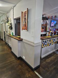a bar in a restaurant with a picture on the wall at Dudley Port in Ocker Hill