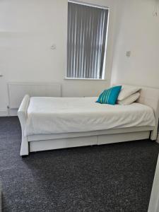 a bed in a white room with a window at Dudley Port in Ocker Hill +61 photos