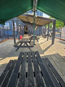 a bench sitting under a canopy at a bus stop at Dudley Port in Ocker Hill