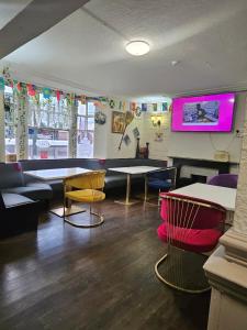 a room with a table and chairs and a tv at Dudley Port in Ocker Hill