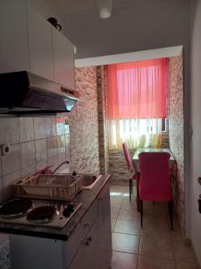 a kitchen with a sink and a red window at Apartment Maya in Banjole