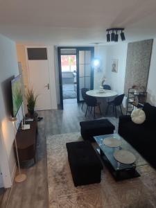 a living room with a couch and a table at Lea Lux apartment Tuzla in Tuzla