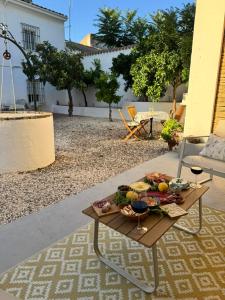 a table with a bowl of fruit and wine glasses at Cortijo Cenascuras in Priego de Córdoba