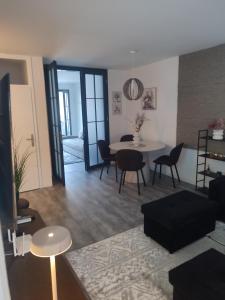 a living room and dining room with a table and chairs at Lea Lux apartment Tuzla in Tuzla