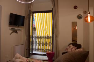 a living room with a door open to a balcony at Pupa1824 casedamare in Lentiscosa