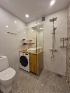 a bathroom with a toilet a sink and a shower at Boose Apart in Kobela +33 photos