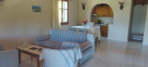 a living room with a couch and a table at Kaiti Villa 4 in Koukounaries