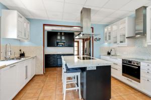 a kitchen with white cabinets and a counter top at Ca'n Cristofal in Felanitx