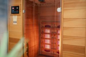 a walk in closet with wooden walls and a glass door at Haus JADEHUUS in Schweiburg +38 photos