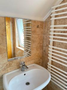 a bathroom with a white sink and a mirror at TaVa House 2 in Yaremche +39 photos