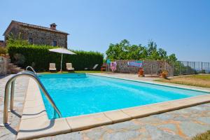 a swimming pool with a slide in a yard at Casa con Piscina Climatizzata - Vecchia Stalla in Casa Montacuto