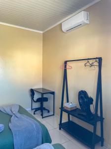 a bedroom with a bed and a desk and a fan at Casa em Condomínio, Jardim, Home Office in Castanhal
