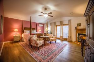 a bedroom with a bed and a table and chairs at The Inn at Stockbridge in Stockbridge