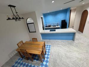 a kitchen with a wooden table and a counter at Casa Laura Azul in El Cuyo