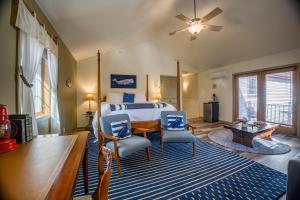a bedroom with a bed and a table and chairs at The Inn at Stockbridge in Stockbridge
