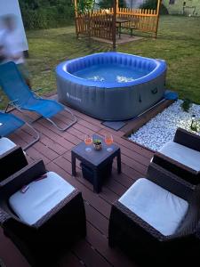 a backyard with a hot tub and chairs and a table at Royal Residence in Visoko
