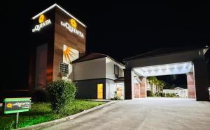 a building with a parking garage at night at La Quinta by Wyndham Morgan City in Morgan City