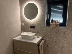 a bathroom with a sink and a mirror at Apartment 45 in Crikvenica +10 photos