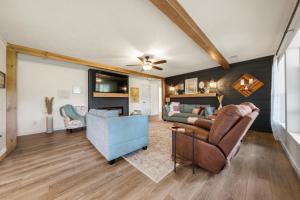 a living room with a couch and a chair at Smallville Farm Retreat in Lake Catherine