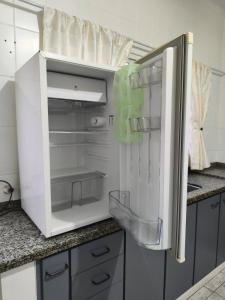 a white refrigerator with its door open in a kitchen at Casa Lyrata in Tatuí +25 photos