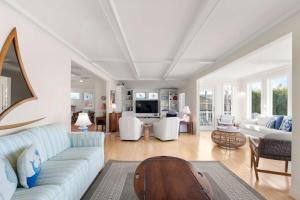 a living room with a couch and a table at Waterfront Private Beach Gorgeous Views in Yarmouth
