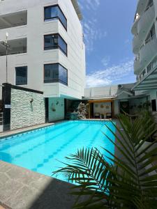 a swimming pool in front of a building at Hotel Remanso in Chimbote