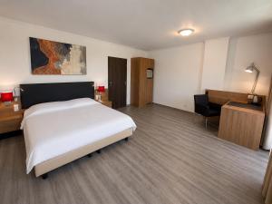 a hotel room with a bed and a desk and a chair at M14 Stay Cluj in Cluj-Napoca +3 photos