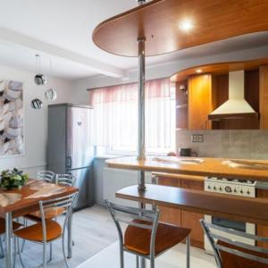 a kitchen with a table and chairs and a dining room at Pensjonat Koral in Kołobrzeg