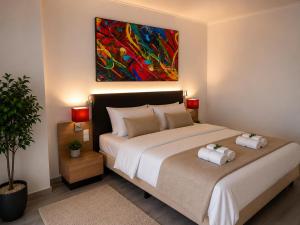 a bedroom with a bed with two towels on it at M14 Stay Cluj in Cluj-Napoca