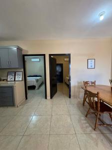 a kitchen with a table and a room with a bed at Departamento #1 in San Carlos